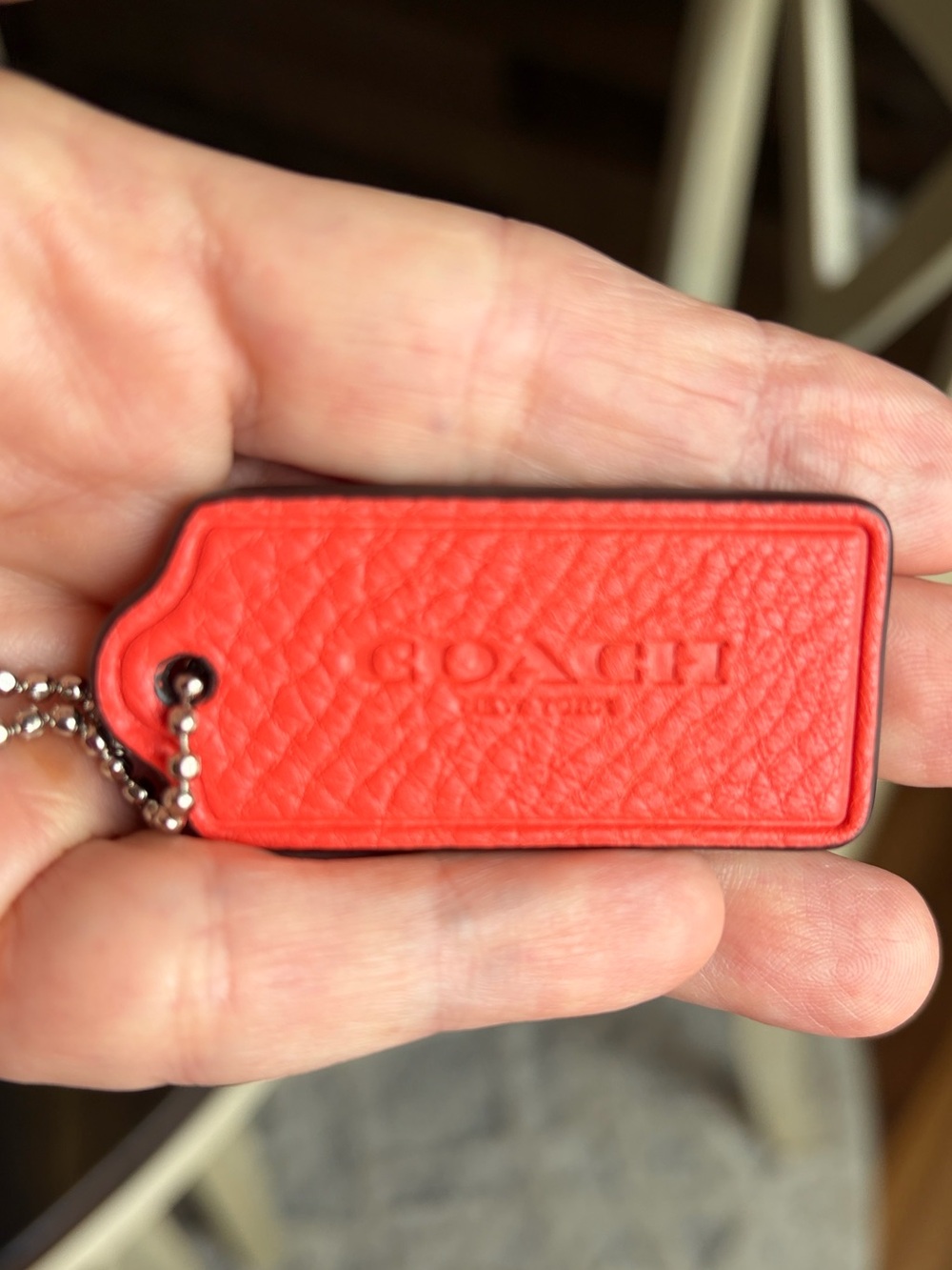 Coach Orange Pebbled Leather Hang Tag Keychain with silver